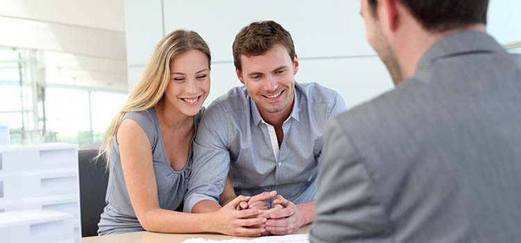 Couple signing loan papers