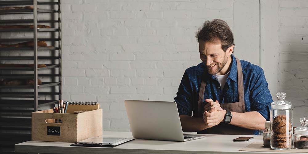 Baker looking at a laptop